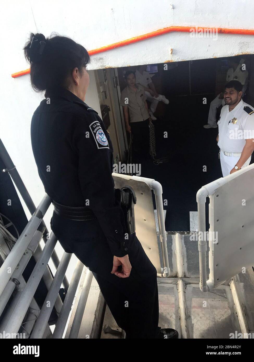 CBP West Palm Beach Port Director Jennifer Connors greets the crew from the Bahamas Paradise Cruise line as their ship Grand Celebration arrives in the Port of Palm Beach, Fla., Sept. 7, 2019. U.S. Customs and Border Protection continues to support rescue and recovery efforts in the Bahamas following the devastating impact of Hurricane Dorian. CBP is working with the Bahamas Paradise Cruise Line and is prepared to process the arrivals of passengers evacuating from the Bahamas according to established policy and procedures. Stock Photo
