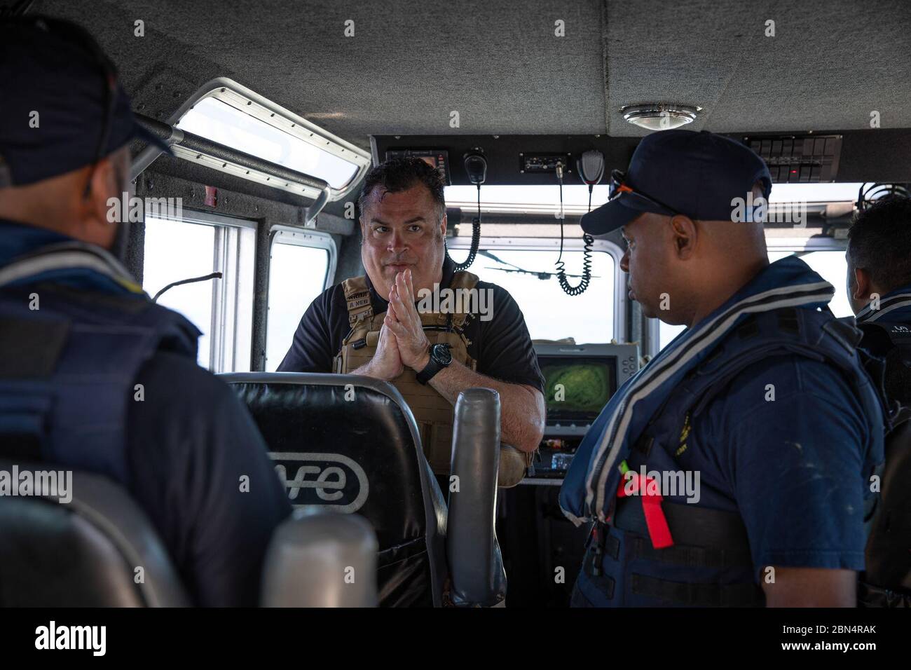 A Marine Interdiction agent with U.S. Customs and Border Protection Air and Marine Operations debriefs a crew from Trinidad and Tobago Customs and Excise Marine Interdiction Unit off the coast of Chaguaramas, Trinidad, on Sept. 26, 2019. AMO agents conducted maritime enforcement training for TTCE officers for two weeks. CBP Stock Photo