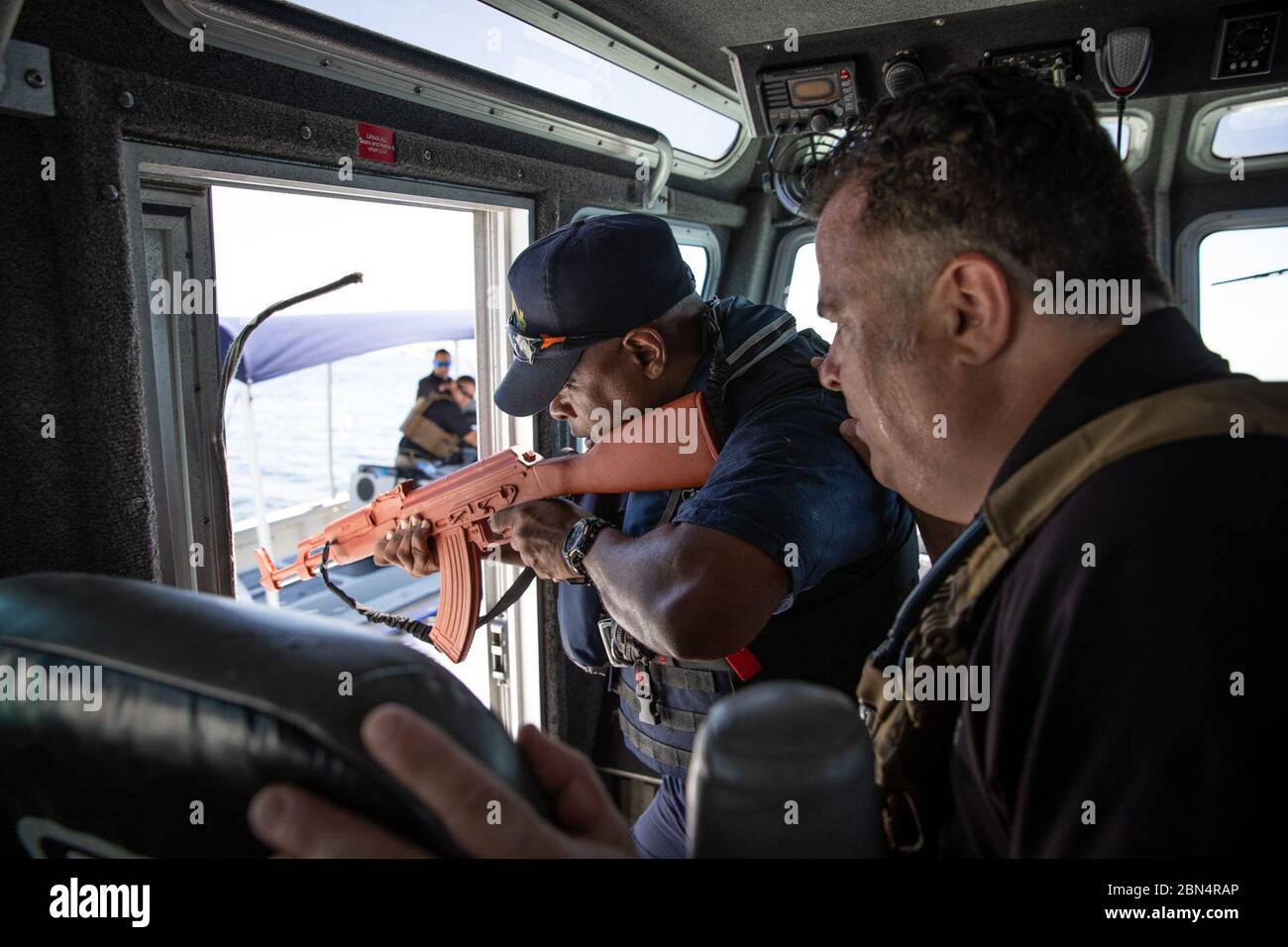 A marine interdiction agent, right, with U.S. Customs and Border Protection Air and Marine Operations instructs a crew member from Trinidad and Tobago Customs and Excise’s Marine Interdiction Unit off the coast of Chaguaramas, Trinidad, Sept. 26, 2019. AMO conducted maritime enforcement training for TTCE officers for two weeks. CBP Stock Photo