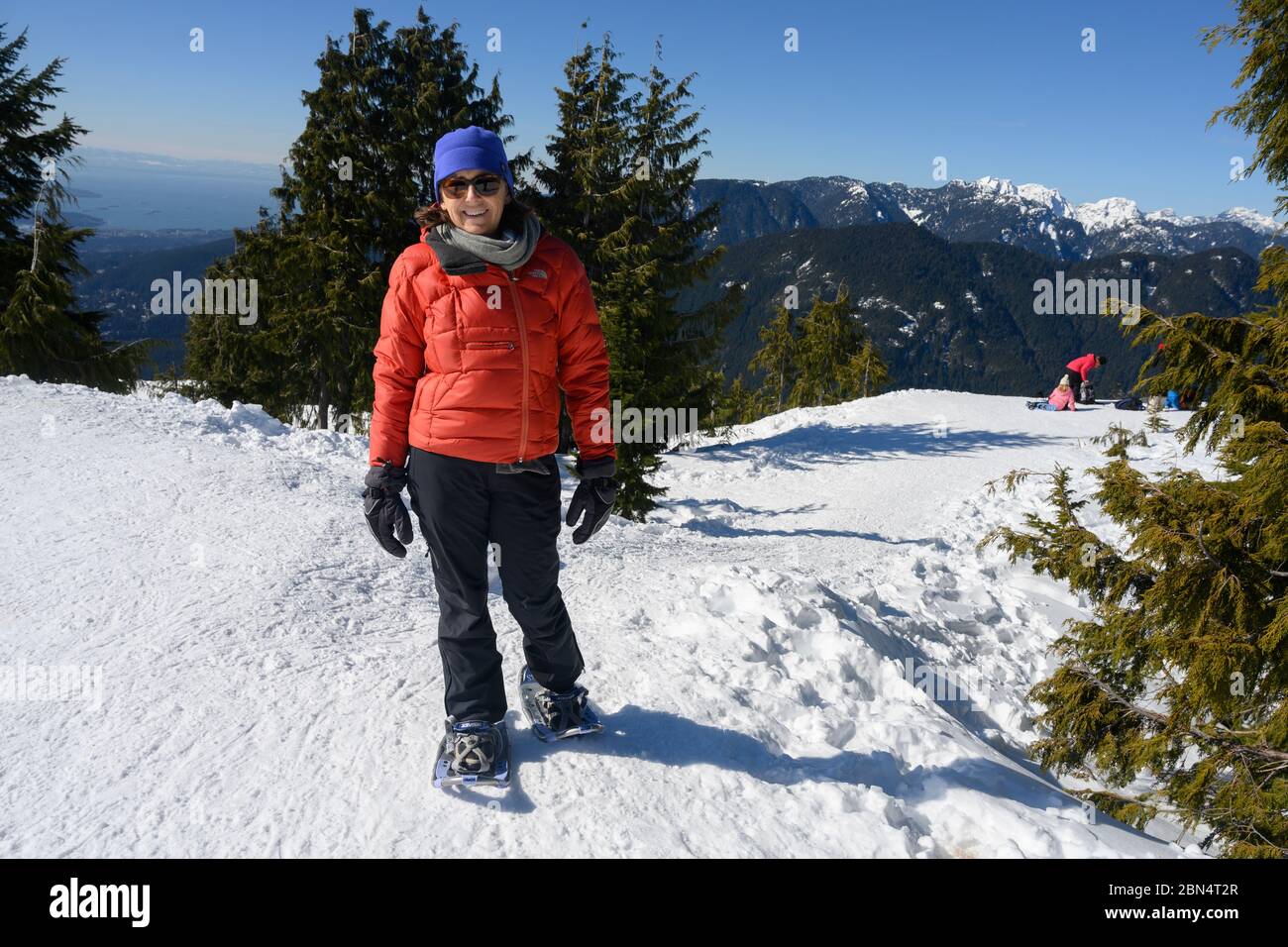 Woman wearing snowshoes standing in snow, Mount Seymour Provincial Park