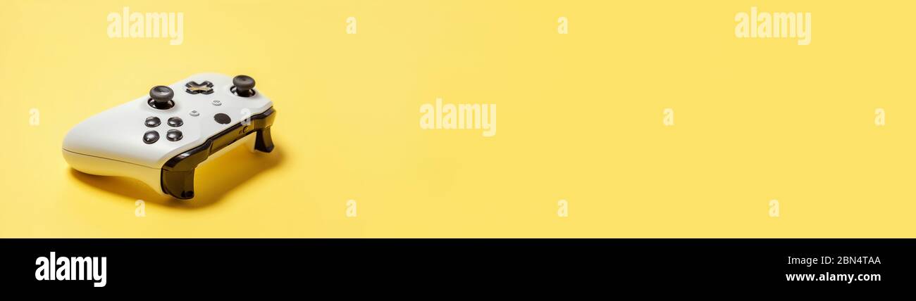White joystick gamepad, game console isolated on yellow colourful ...