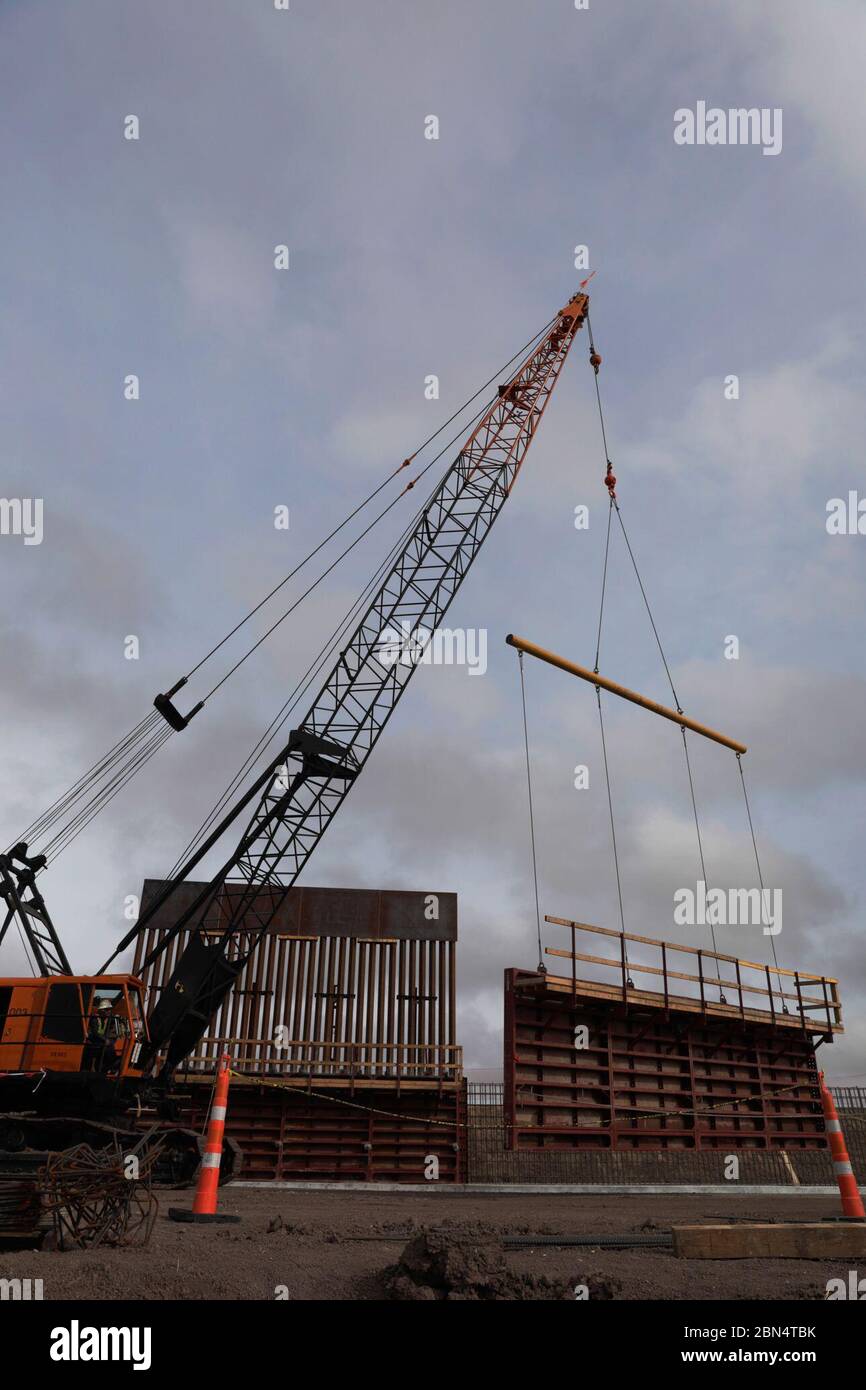 Construction crews work to erect levee wall system in a remote area south of Weslaco, Texas in