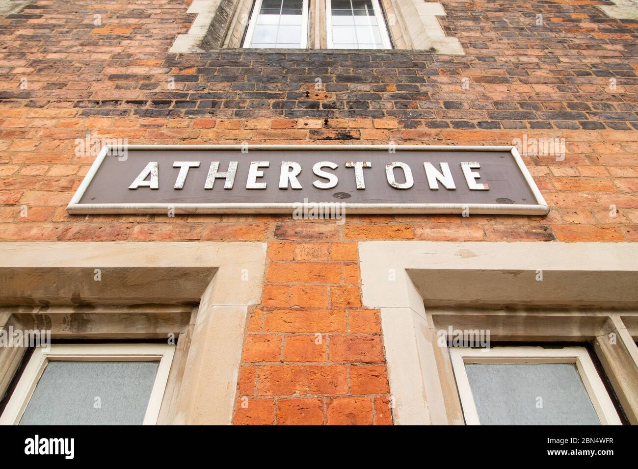 The old original train signs on the side of the platform buildings on the London North Western train station, Atherstone, North Warwickshire. The station was once a main line station, it now has trains running to London, although high speed trains pass directly through the station. Stock Photo