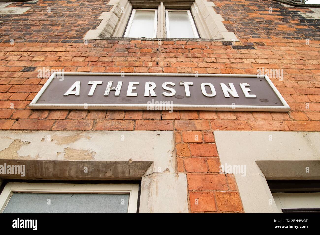 The old original train signs on the side of the platform buildings on the London North Western train station, Atherstone, North Warwickshire. The station was once a main line station, it now has trains running to London, although high speed trains pass directly through the station. Stock Photo
