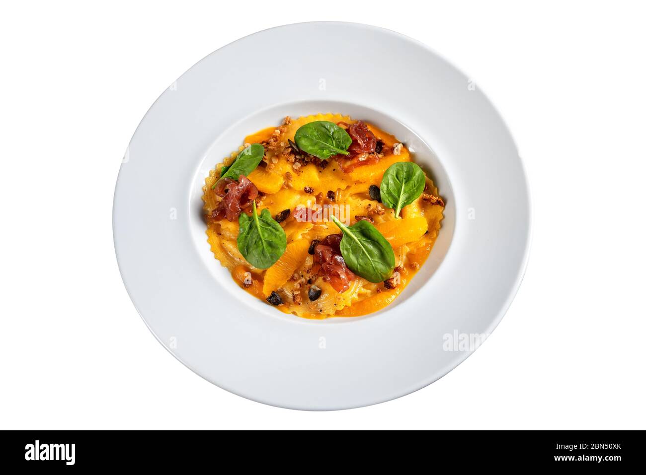 Italian dish, pasta ravioli with spinach and orange. On white background. Stock Photo