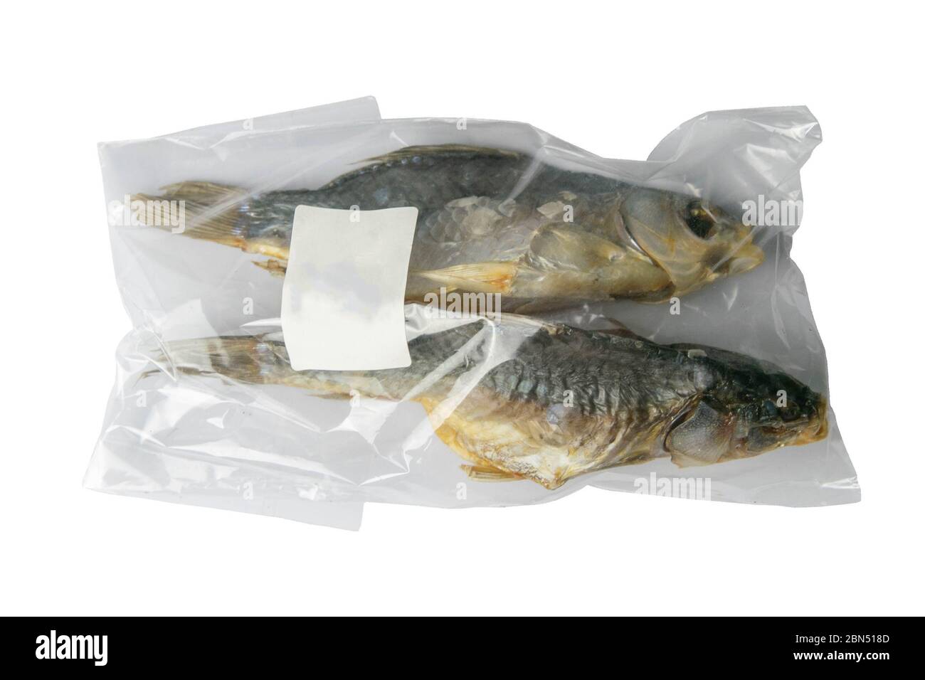 Dried salted crucian fishes in a transparent package with a white label isolated on white background. Snack to beer Stock Photo