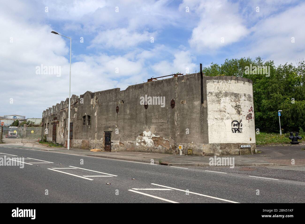 Derelict concrete wall, outside of Technical Demolition Services site, Dock Road, Wallasey. Stock Photo