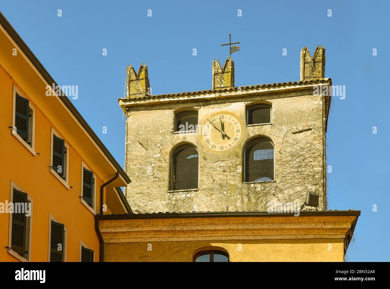 Top of the medieval clock tower of the old town of Garda, Verona province, Veneto, Italy Stock Photo