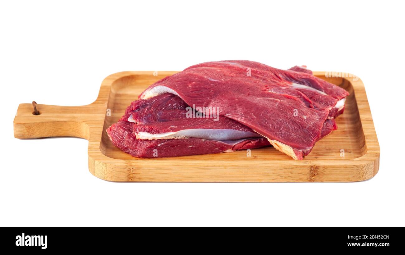 Raw meat on wooden board isolated on white background Stock Photo - Alamy