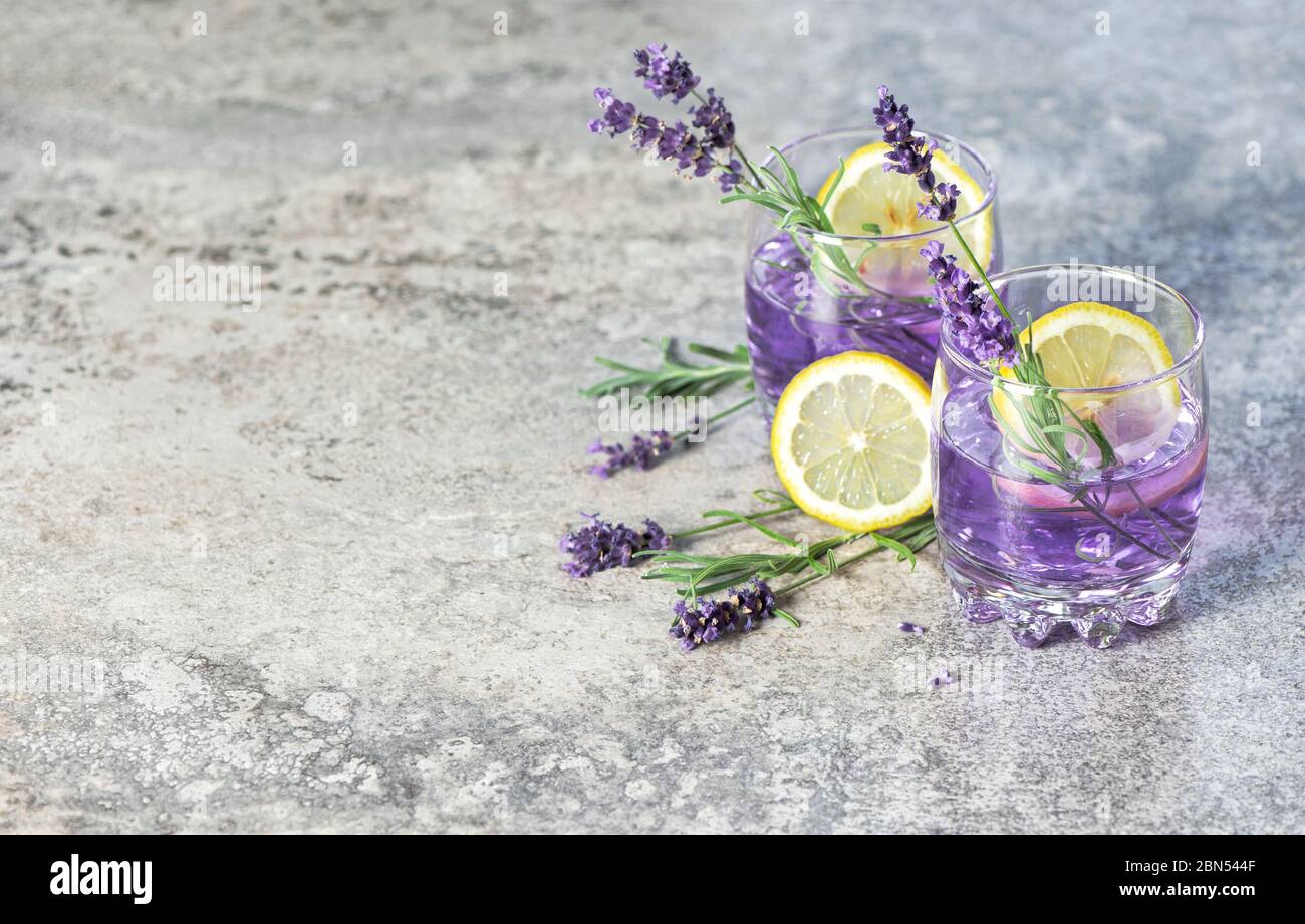 Drink with lemon and lavender herb flowers. Cold summer lemonade Stock Photo