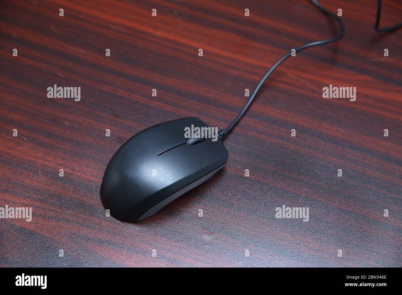 Mouse Red furniture on the table . A black computer mouse . Stock Photo