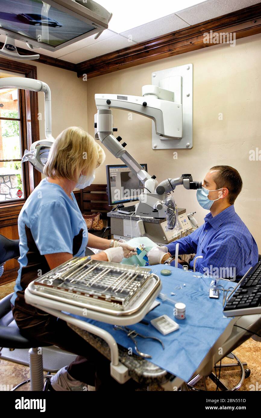 Boise, Idaho, A dentist and dental hygienist performing a procedure on a patient in a modern