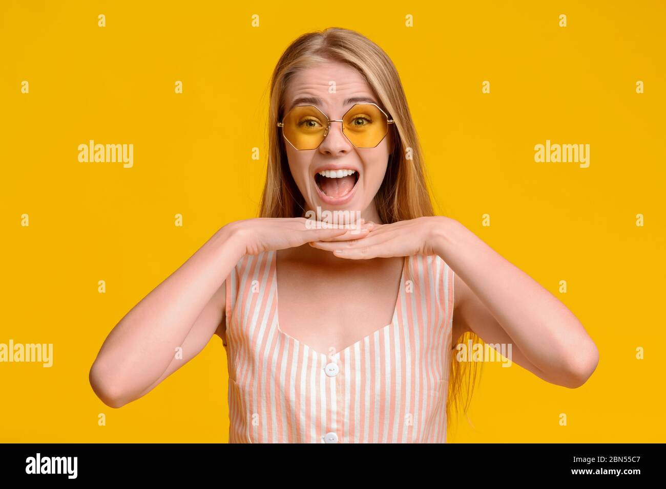 Crazy Sales. Overjoyed Teen Girl Resting Chin On Hands And Shouting Stock Photo