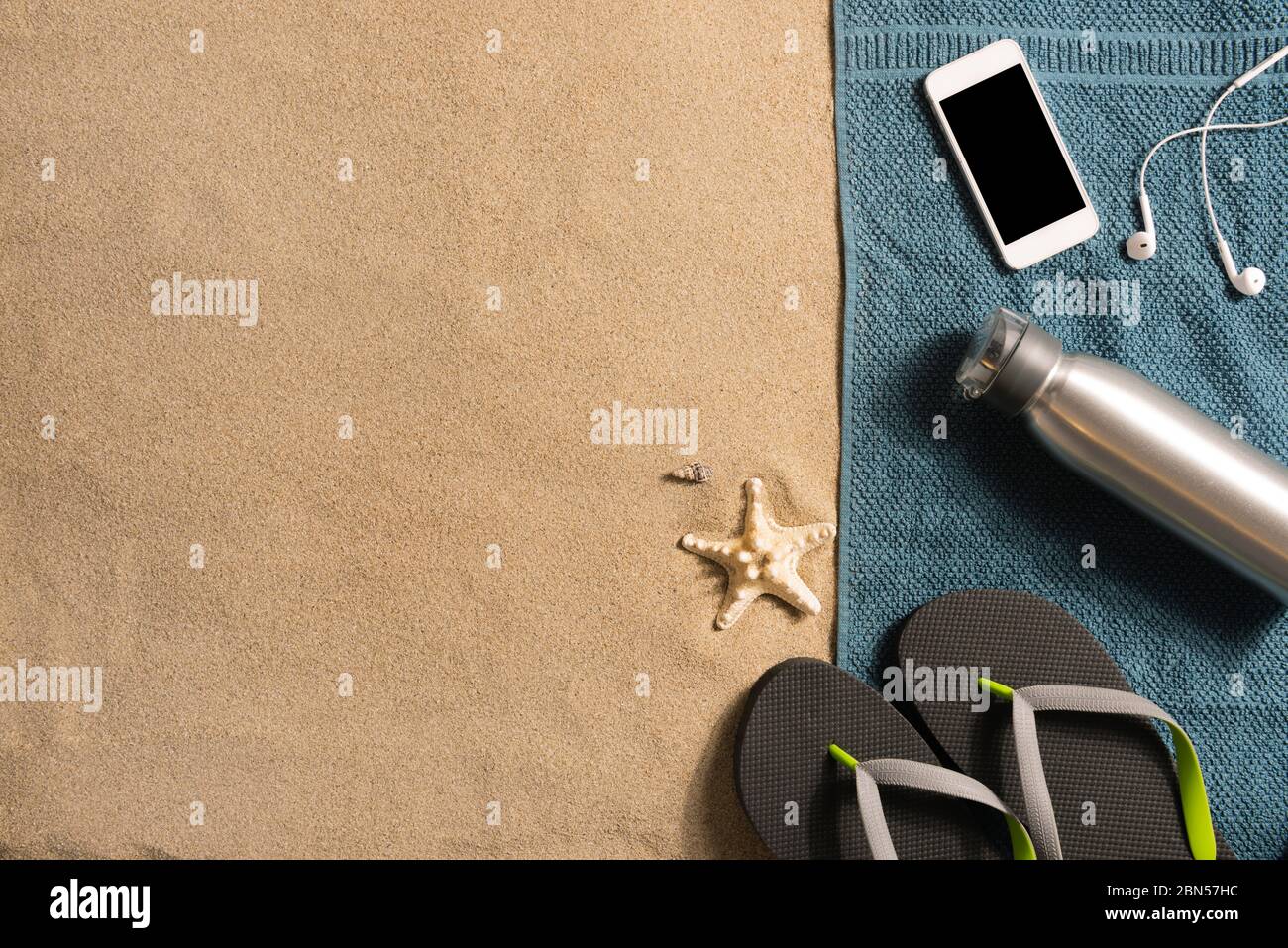 Beautiful summer holiday beach background with flip flops, water bottle