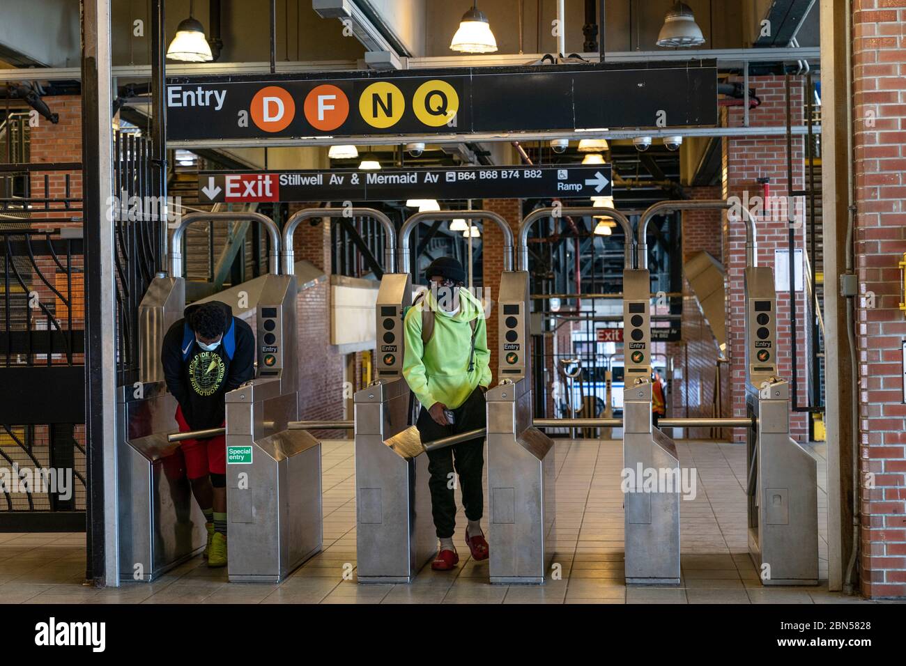 New York, NY May 12, 2020 Straphangers wearing facial masks exiting last stop of subway line