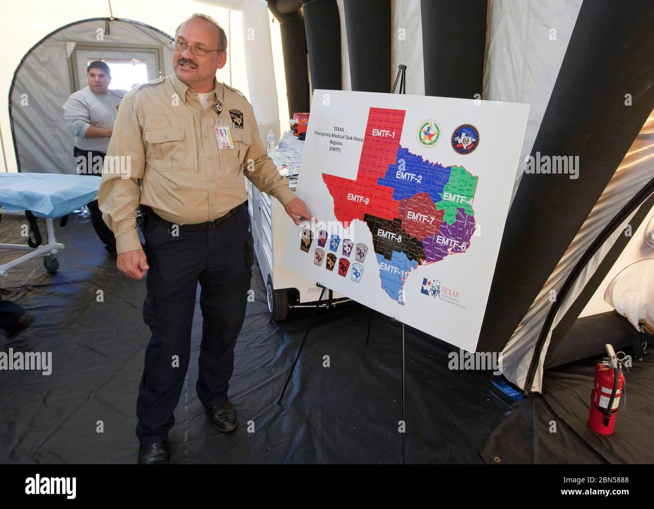 Austin Texas USA, June 1 2012: Member Texas's emergency management office shows a map of the state's emergency districts at a press conference at a mobile medical facility during a hurricane preparedness drill. ©Bob Daemmrich Stock Photo