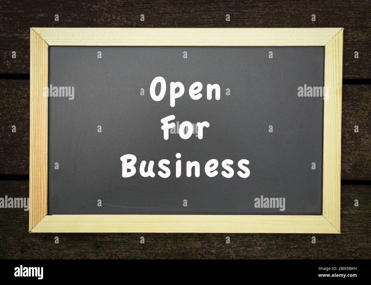 Open for business, words on blackboard. Notice or announcement. Stock Photo
