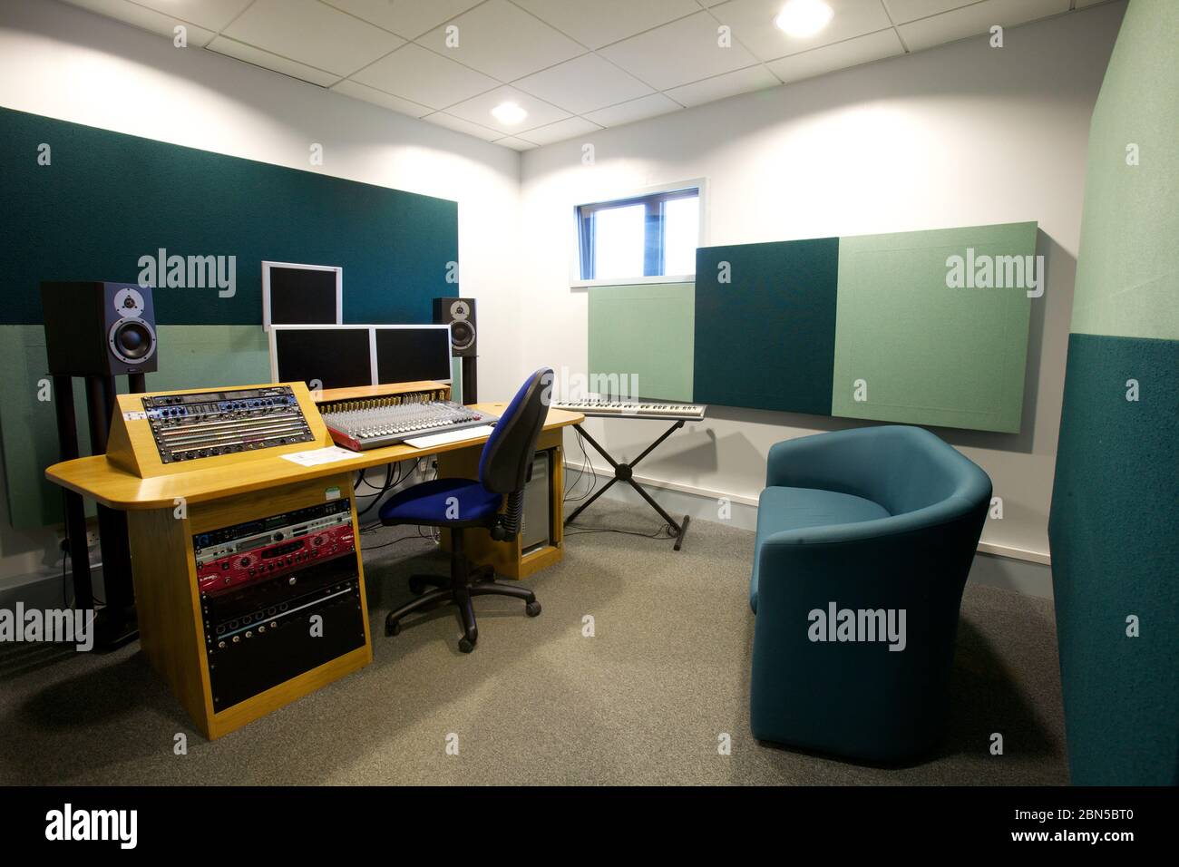 Sound studio with speakers, monitors, a sound board and sound absorbers on the walls, Stock Photo