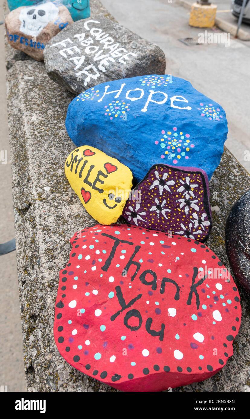 Hand painted rocks line the entrance to Soldiers Memorial Hospital in Orillia Ontaria as a tribute to health care workers fighting coronavirus. Stock Photo