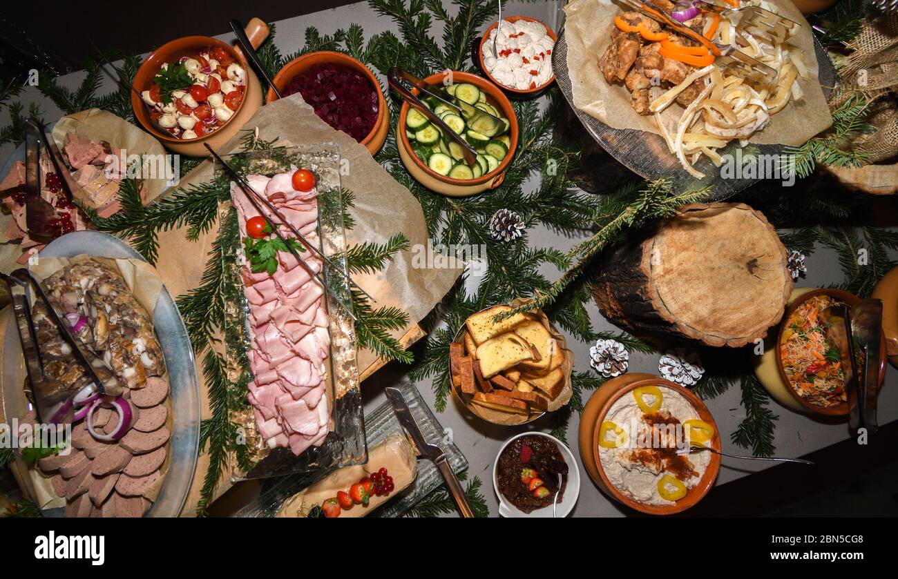 Romanian traditional Christmas food buffet with caltabos, toba and pork meat cuts, ham, platters with variety of dishes. Fresh Food Buffet Brunch Cate Stock Photo