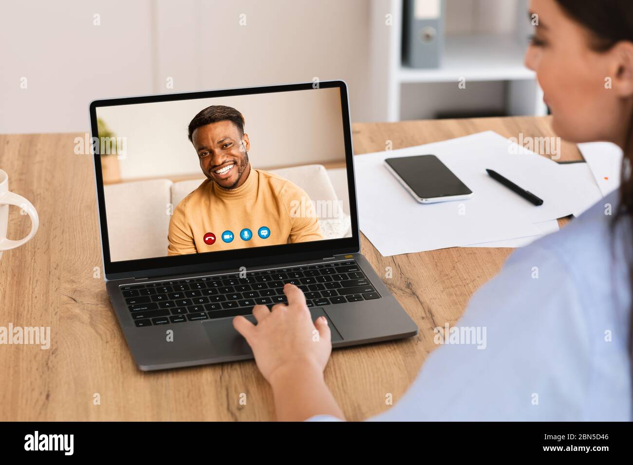 Woman having discussion during video call with colleague Stock Photo