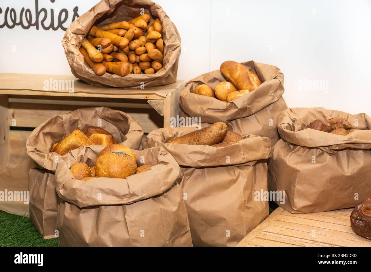 Selection of Fresh baked bread baskets and paper bags with bread