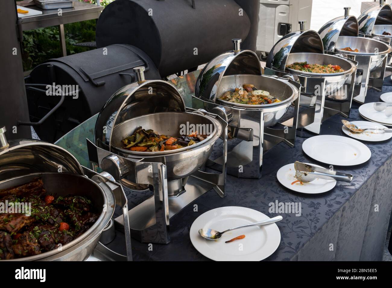 Live food stations. Kitchenware in the line catering summer brunch buffet  food luxury hotel outdoor outside garden by the pool al fresco  restaurant.Co Stock Photo - Alamy