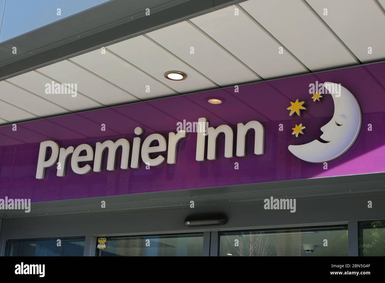 Premier Inn business sign and logo consisting of crescent moon and stars. Stock Photo