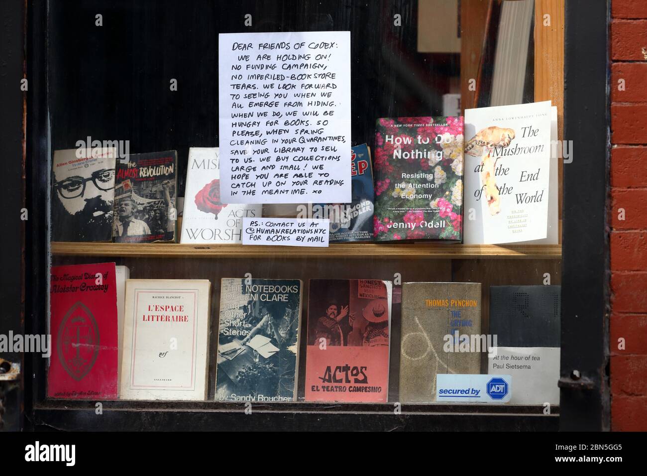 A hopeful sign in the window of Codex, an indie bookstore in the East Village of New York during the coronavirus COVID-19 crisis. Stock Photo