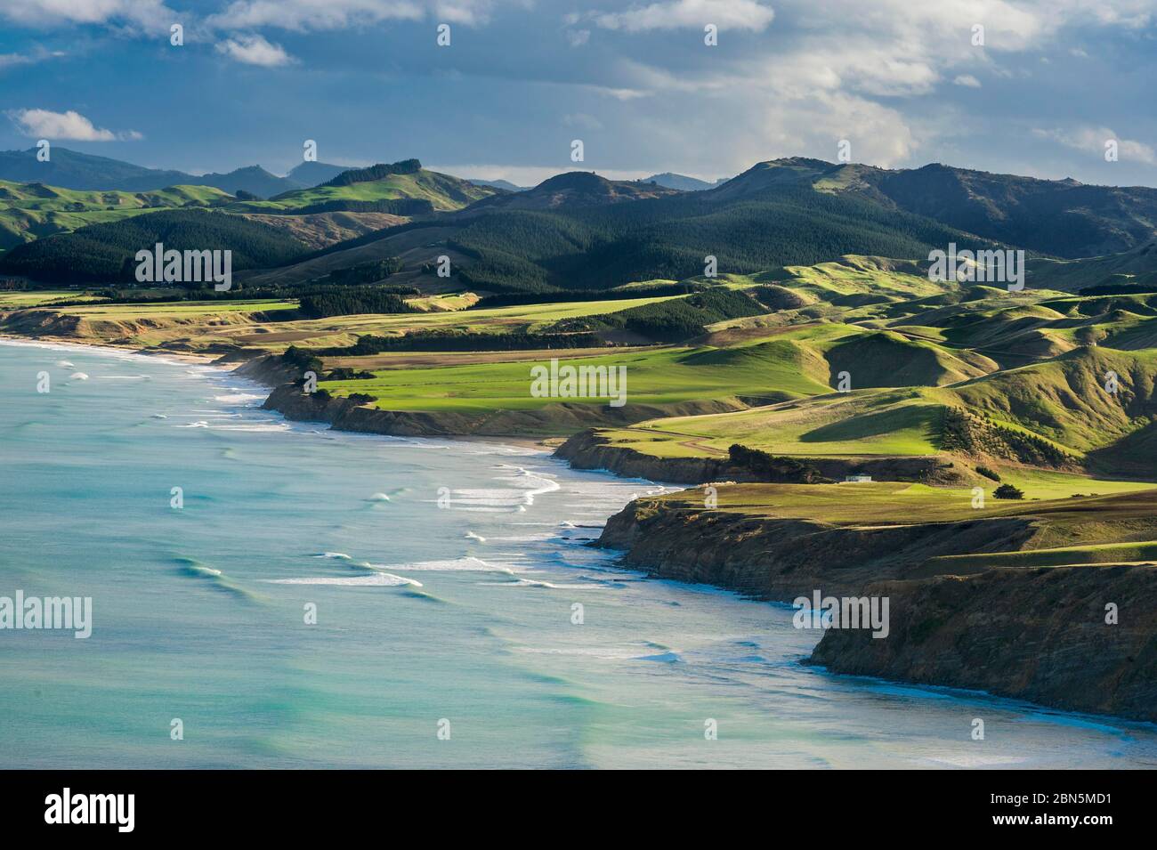 Castlepoint coastline, mountain landscape with green hills and pasture land, Masterton, Wellington, New Zealand Stock Photo
