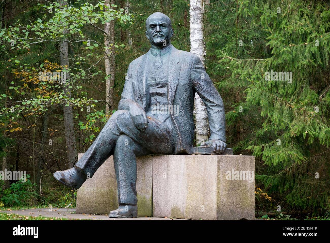 A large, bronze statue of a sitting Lenin with a book. At Gruto Parkas near Druskininkai, Lithuania. Stock Photo