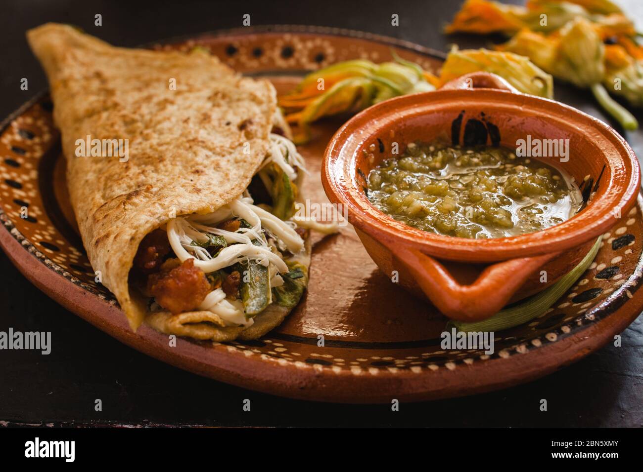 mexican quesadilla with squash blossom, cheese and spicy sauce in