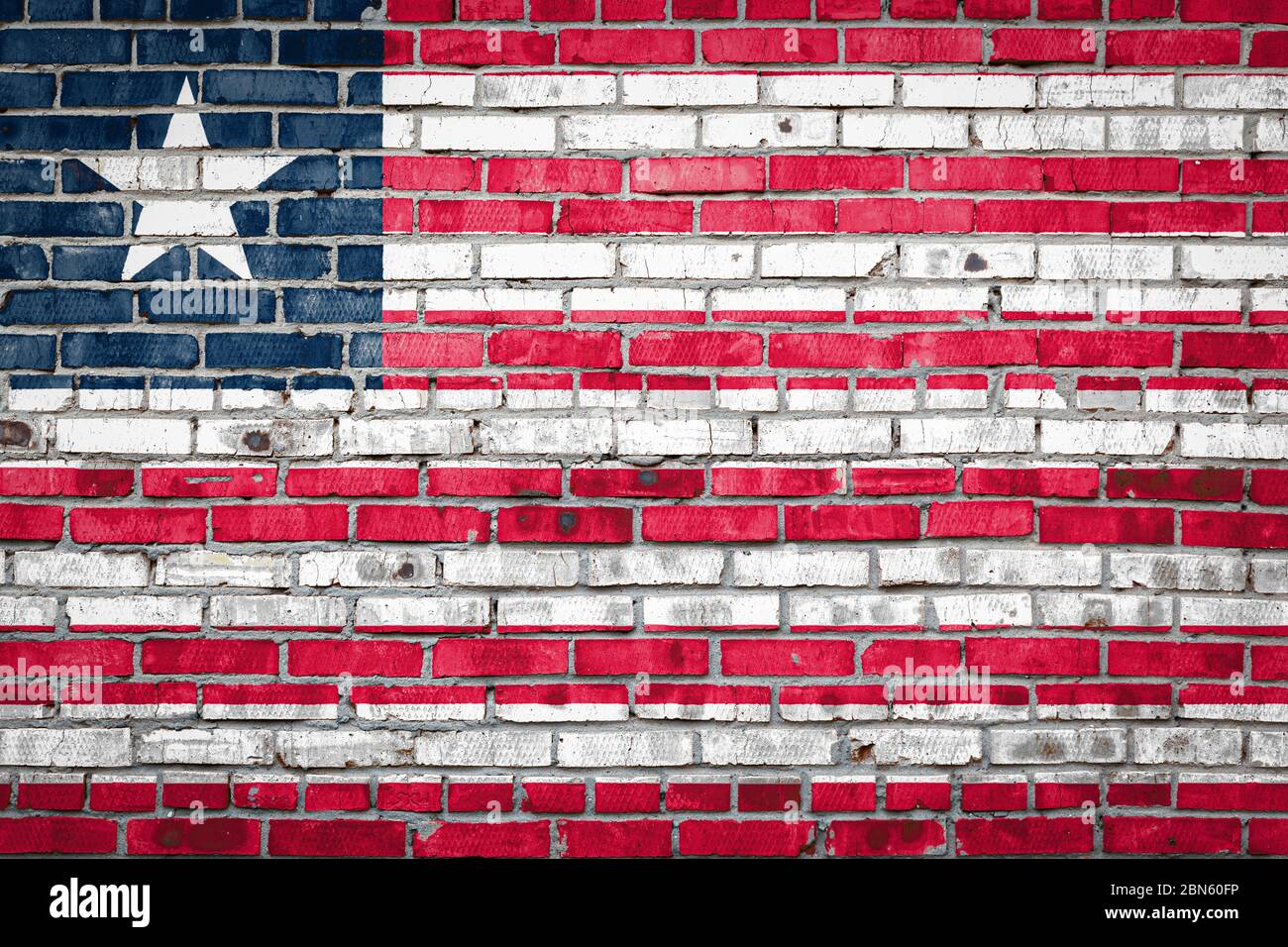 National flag of Liberia depicting in paint colors on an old brick wall ...
