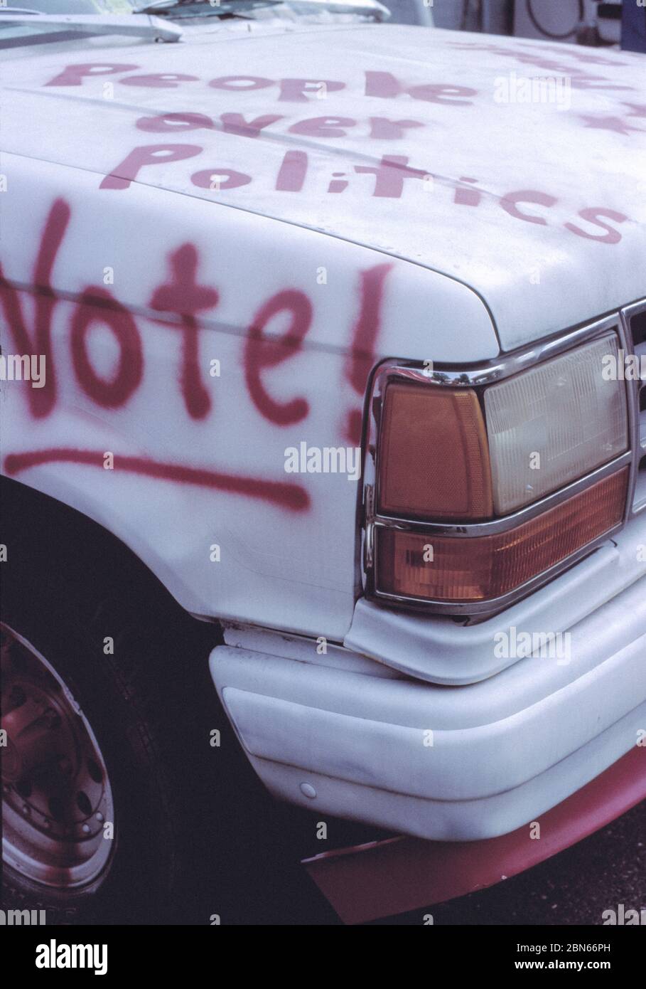 ELECTION VOTE SIGN IN WASHINGTON DC. PEOPLE OVER POLITICS CAR GRAFITTI WITH DC FLAG. Stock Photo