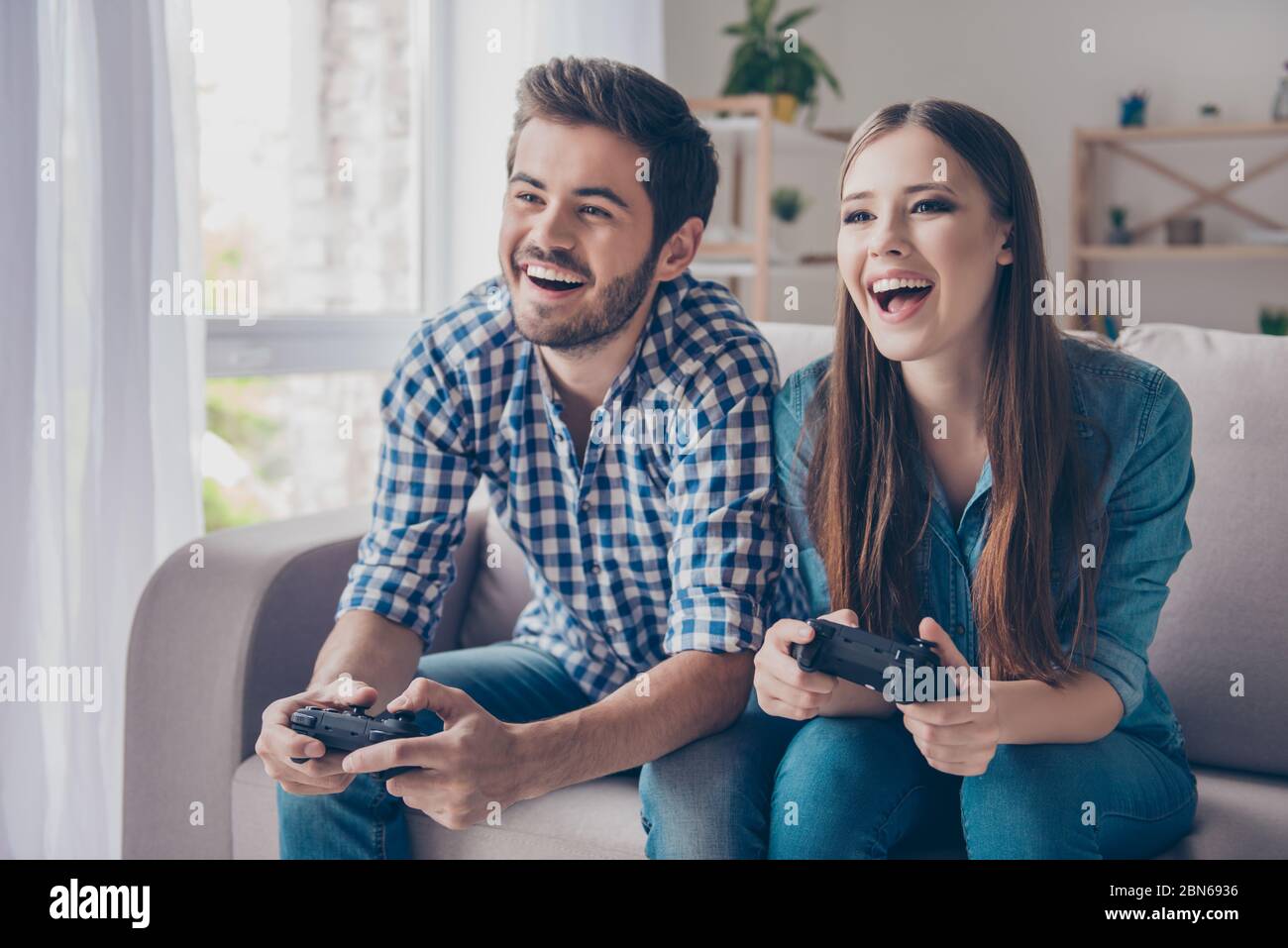 Who will win? Excited funny friends, playing video games at home, sitting on sofa and enjoying themselves. They have great weekend in nice company Stock Photo - Alamy Who will win? Excited funny friends, playing video games at home, sitting on sofa and enjoying themselves. They have great weekend in nice company Stock Photo - Alamy