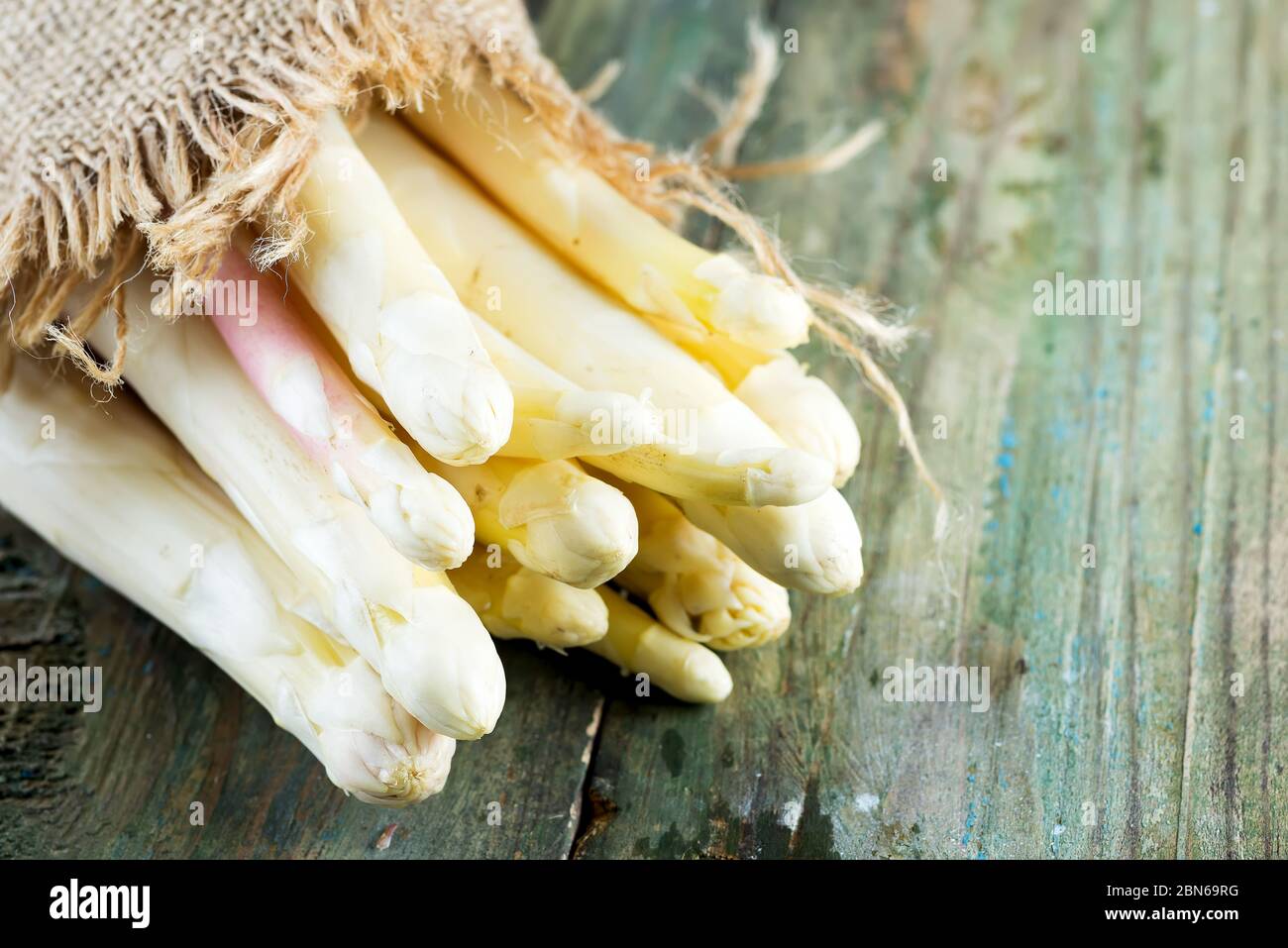 Freshly picked natural organic bunch of white asparagus vegetables on a wooden background. Stock Photo