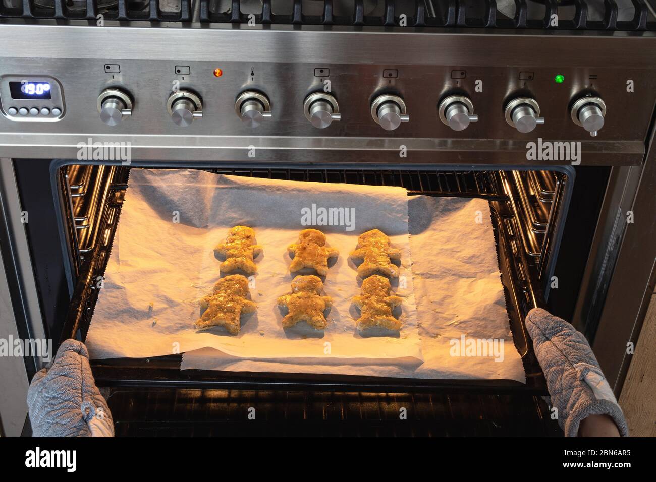 Baking Gingerbread man in the oven, Woman making homemade gingerbread ...