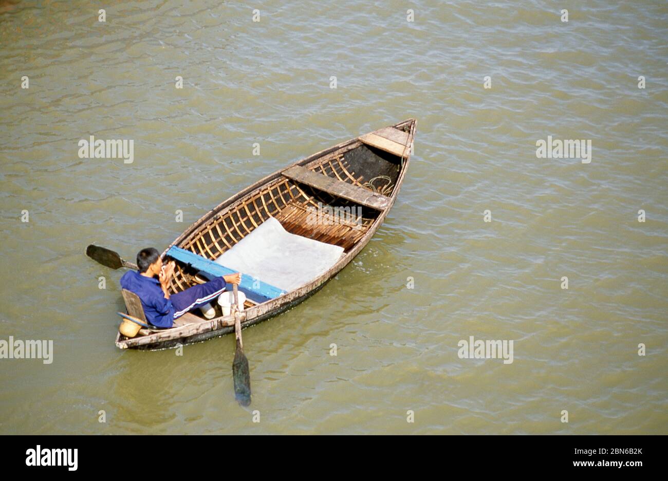Vietnam: Leg rower in the harbour, Nha Trang, Khanh Hoa Province.  Nha Trang is a coastal city and capital of Khanh Hoa province, on the South Central Stock Photo