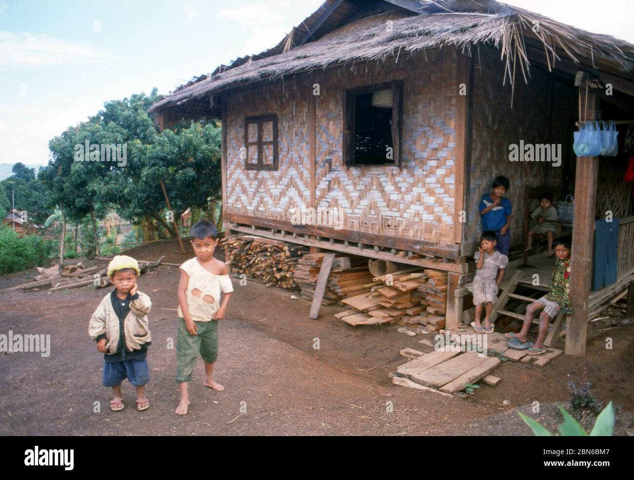 Burma / Myanmar: Village boys and house near Pyin U Lwin (Maymyo), Mandalay Region.  Pyin U Lwin (Maymyo) began as a military outpost on the Lashio-Ma Stock Photo