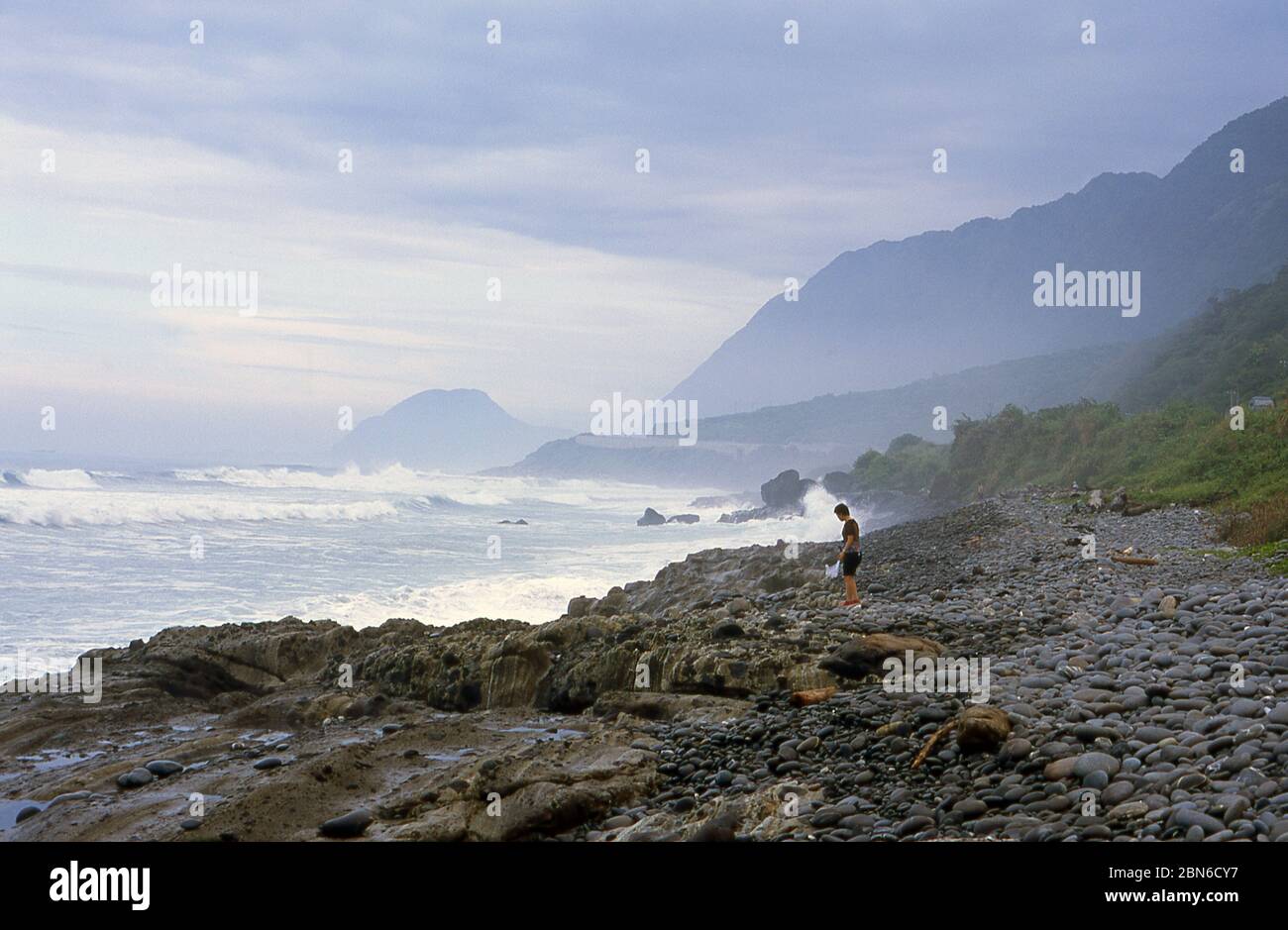 Taiwan: An Amis beachcomber collecting sea-washed marble pebbles, Taiwan.  The Amis (also Ami or Pangcah) are an Austronesian ethnic group native to T Stock Photo