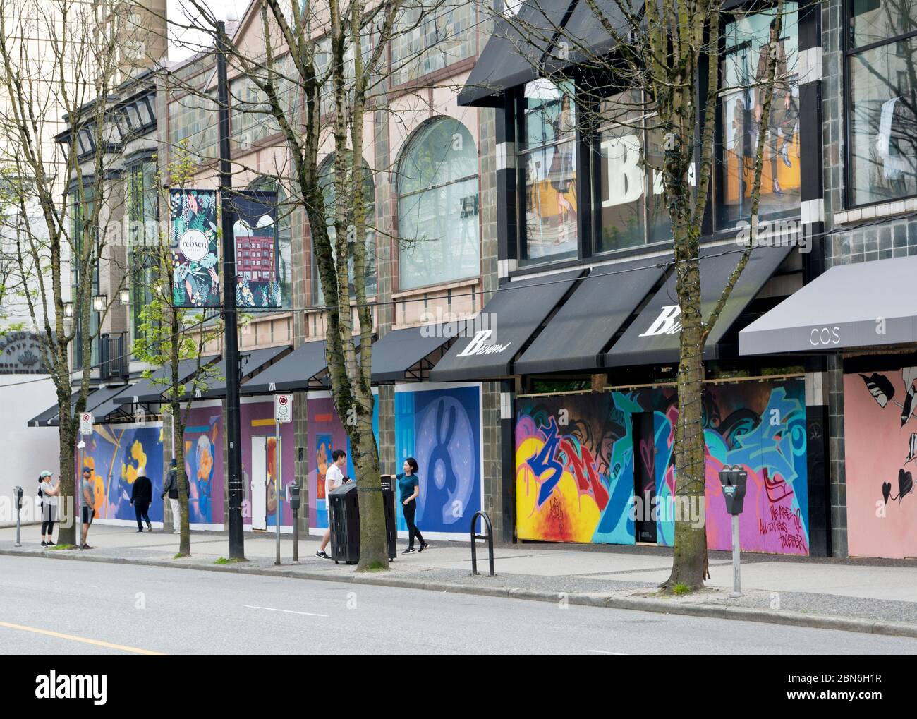 May 9, 2020: Boarded up shops on Robson Street in Vancouver, covered with inspiring murals during the Covid 19 pandemic. Stock Photo