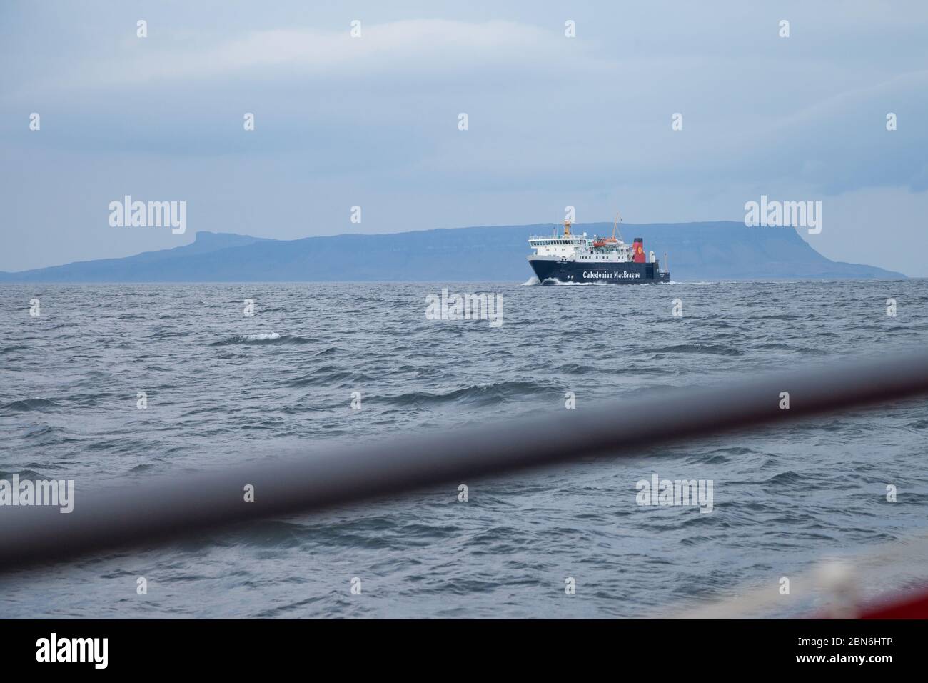 A Caledonian MacBrayne ferry with the Isle of Eigg behind Scotland Stock Photo
