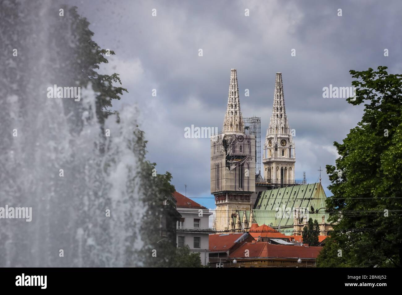 Zagreb, Croatia - 15 April, 2020 : Zagreb cathedral without both crosses on the top of the towers after earthquake that have damage it and water fount Stock Photo