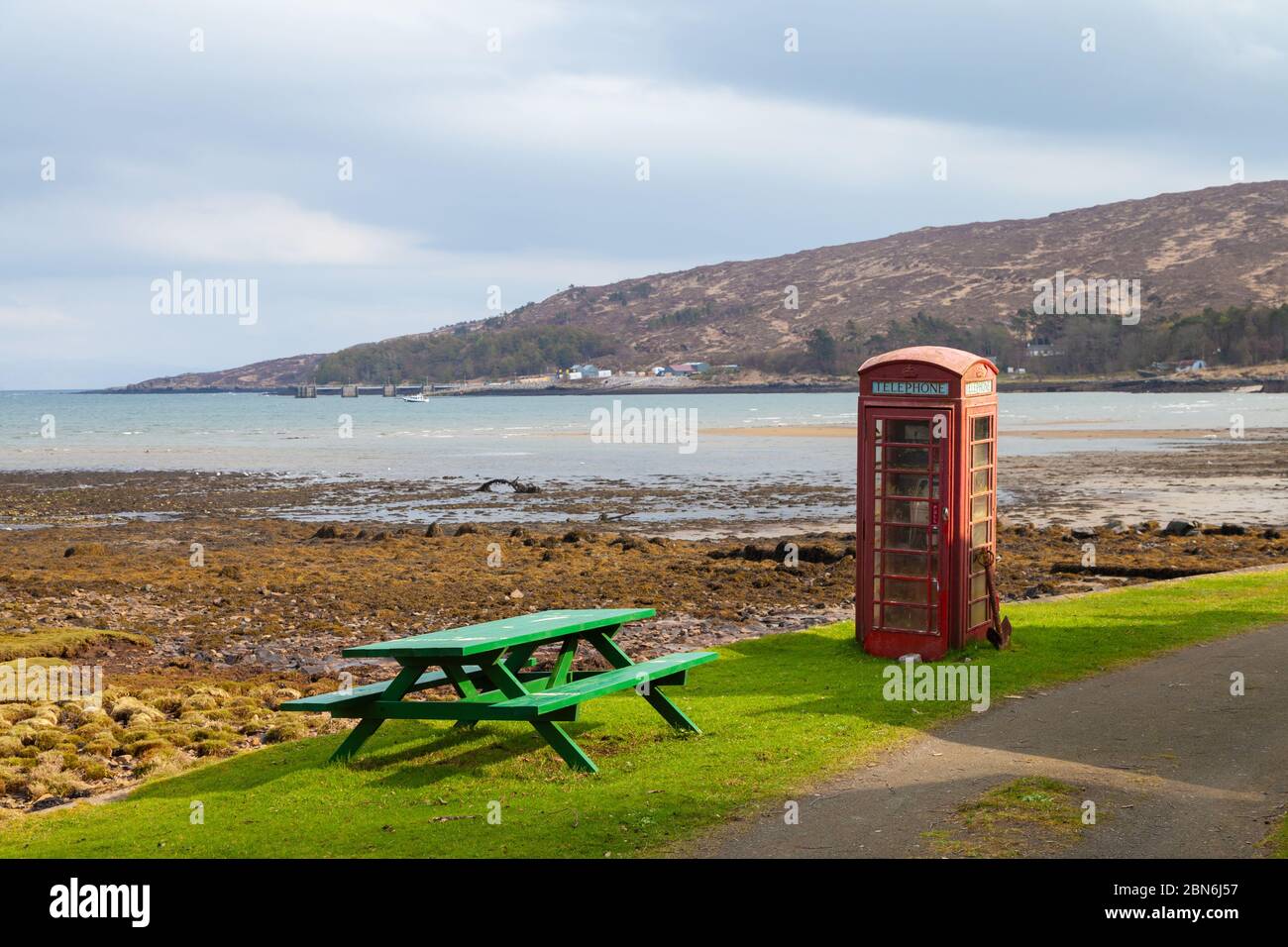 An old red public phone box on the shore of Loch Scresort, Kinloch, Isle of Rum, Scotland Stock Photo