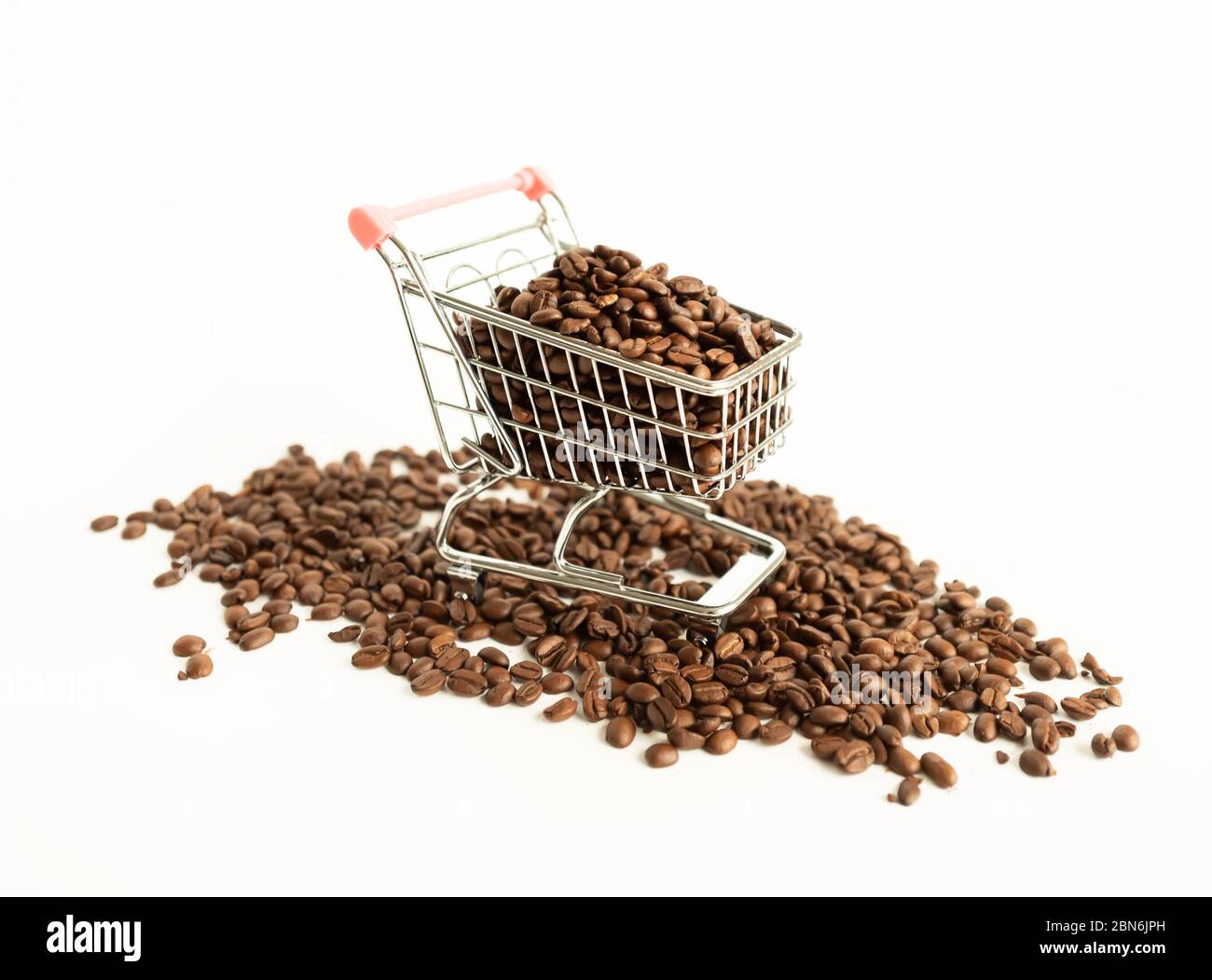 Coffee beans inside small shopping cart on white background Stock Photo
