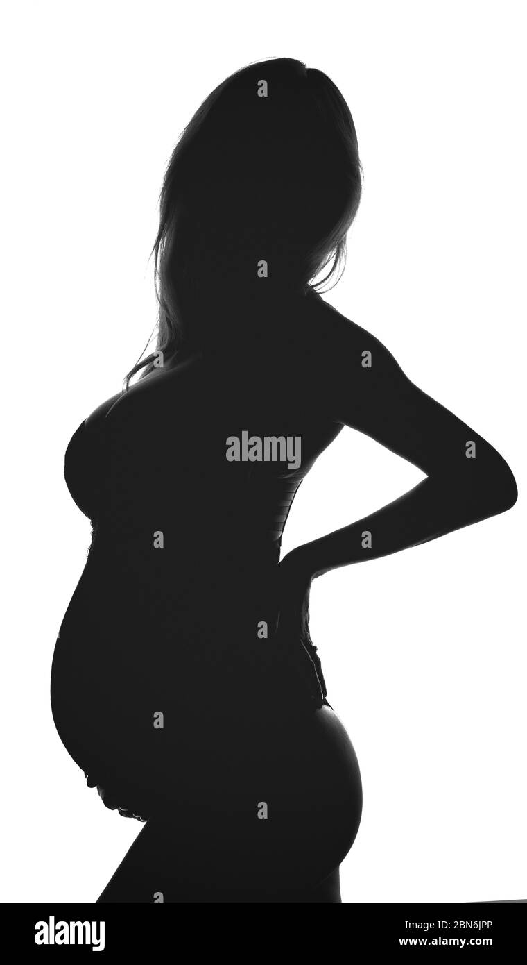 Silhouette of pregnant woman. Backlit black and white profile view Stock Photo