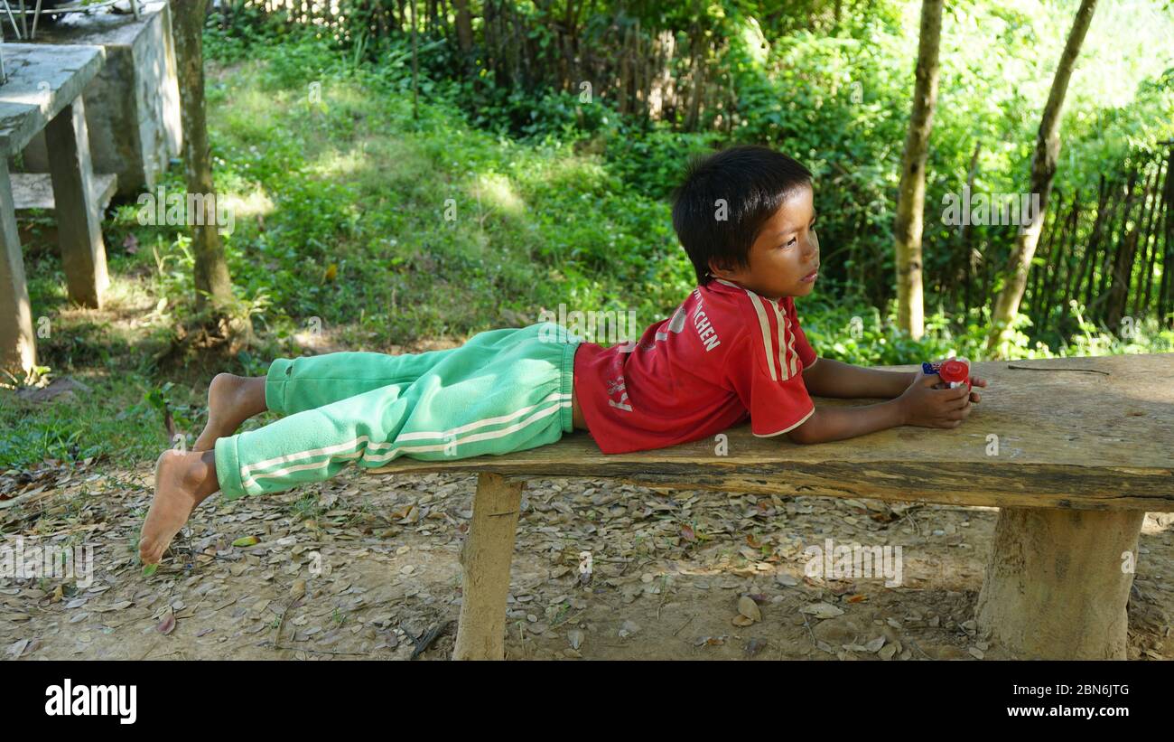 laotian little boy day dreaming Stock Photo
