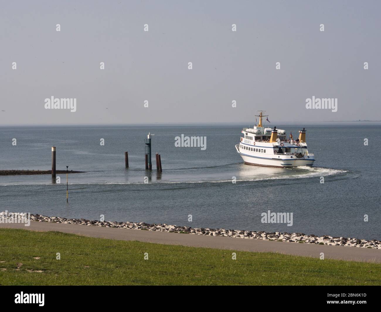 Passenger ferry leaving the harbour of Strucklahnungshörn, Nordstrand, Schleswig-Holstein, Germany for one of the many picturesque Wattenmeer islands Stock Photo