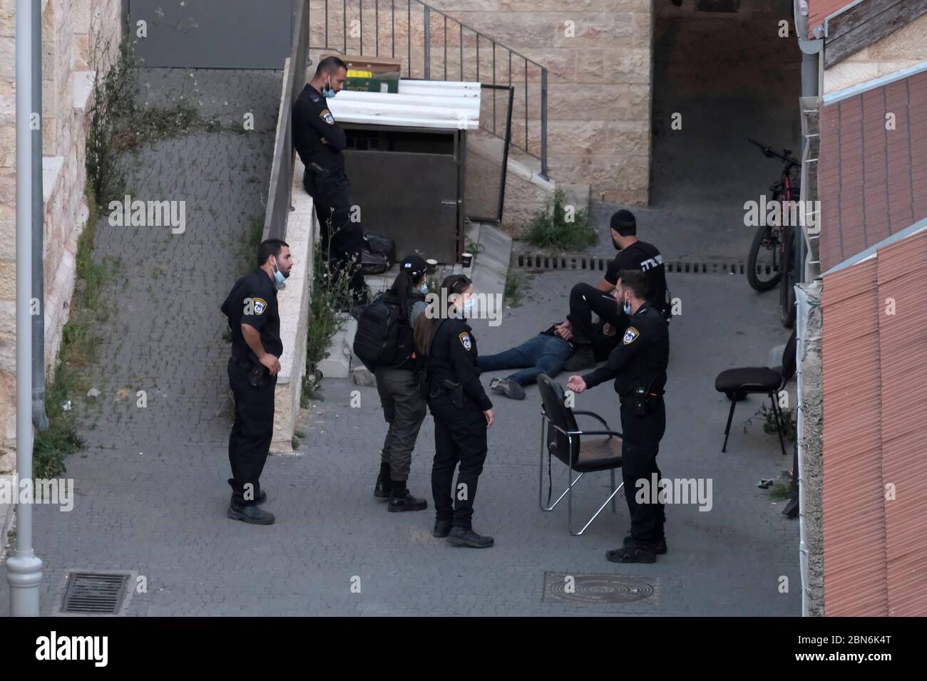 Israeli policemen detain a man inside Migrash Harusim police station in Russian Compound west Jerusalem Israel Stock Photo