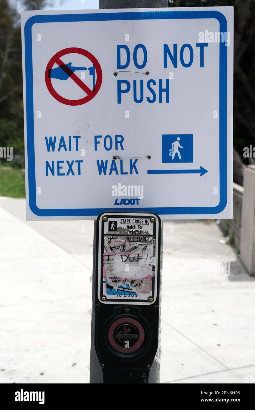 A pedestrian push button at a traffic signal at a crosswalk at the ...